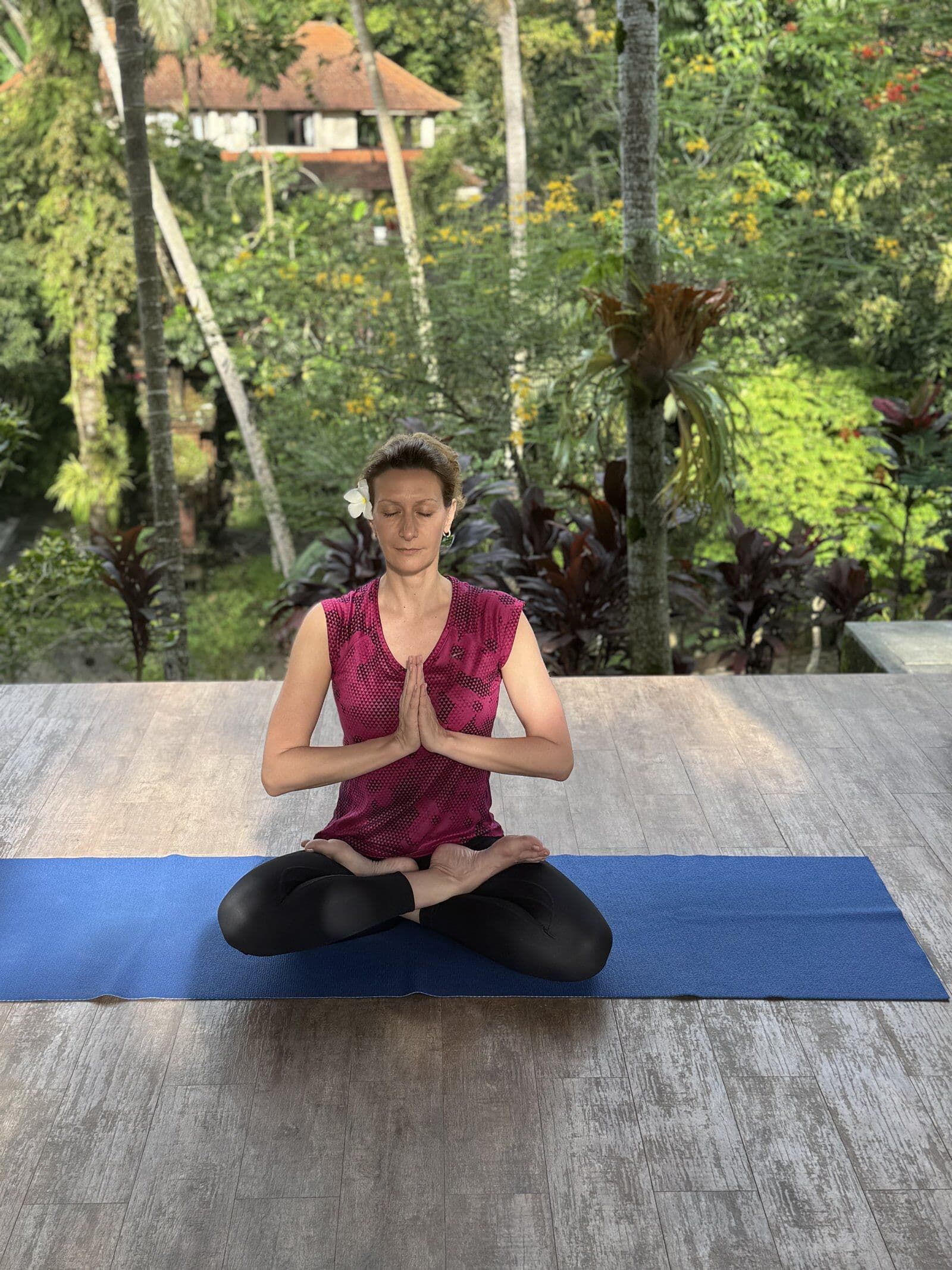 Savelia meditating in a tropical setting